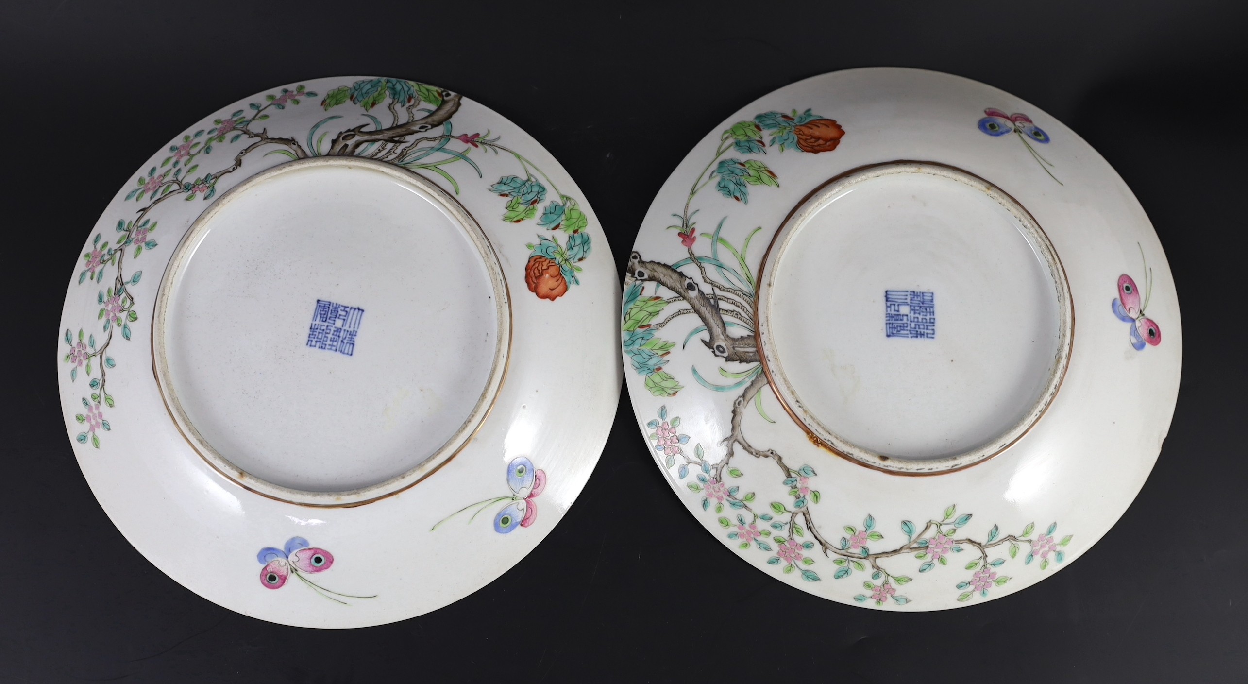 A pair of Chinese enamelled porcelain 'blackbird' dishes, Qianlong seal marks but 19th century, 27cm diameter, minor damage